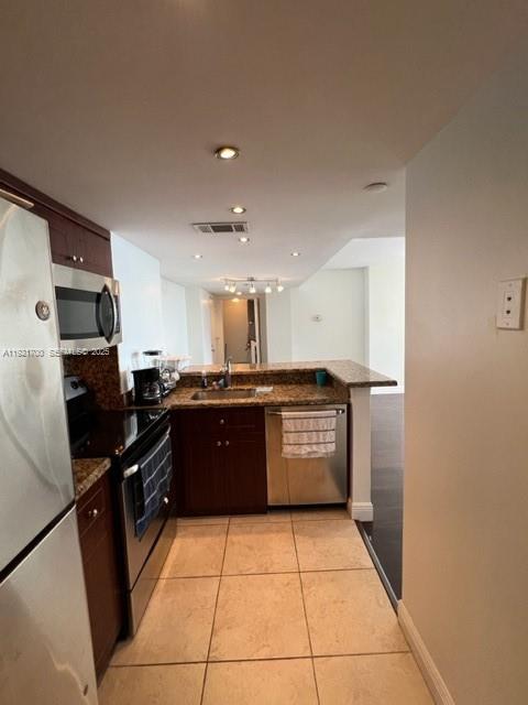 770 Claughton Island Drive, Unit 1404 Miami, FL 33131 - Photo 14 of 23 a large kitchen with a stove a refrigerator and a sink