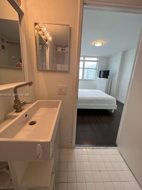 770 Claughton Island Drive, Unit 1404 Miami, FL 33131 - Photo 15 of 23 a bathroom with a sink a vanity and mirror