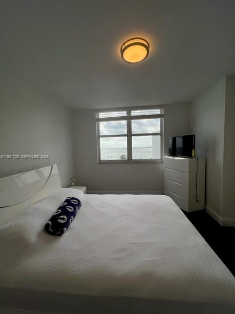 770 Claughton Island Drive, Unit 1404 Miami, FL 33131 - Photo 16 of 23 a bed room with a bed furniture and a window