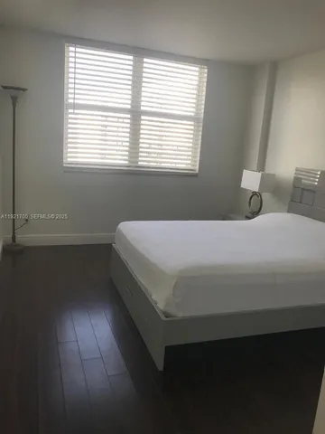 a kitchen with a refrigerator and a sink