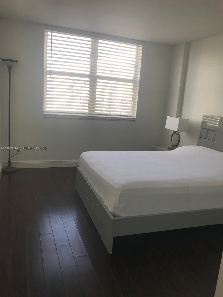 770 Claughton Island Drive, Unit 1404 Miami, FL 33131 - Photo 5 of 23 a bedroom with a bed and a window