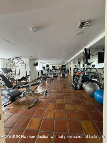 a living room with furniture a wooden floor and kitchen view