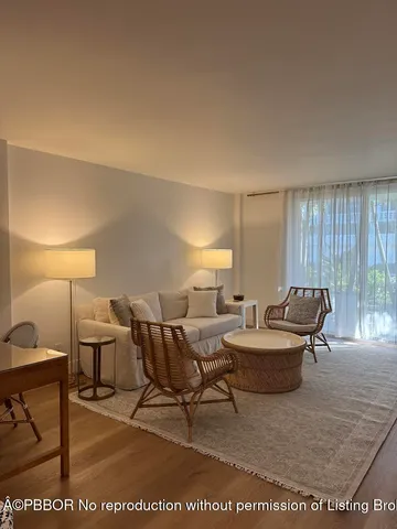 a living room with furniture a window and a table