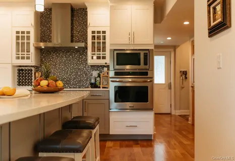 a kitchen with stainless steel appliances a sink a stove and a microwave