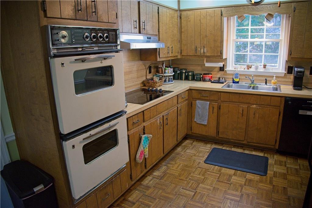 425 Hackberry Lane Roswell, GA 30076 - Photo 13 of 28 a kitchen with a stove sink and cabinets