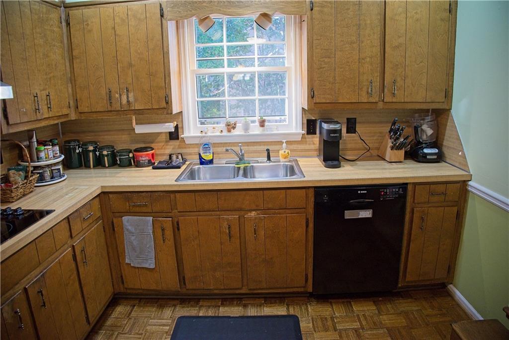 425 Hackberry Lane Roswell, GA 30076 - Photo 14 of 28 a kitchen with stainless steel appliances granite countertop a sink stove and cabinets