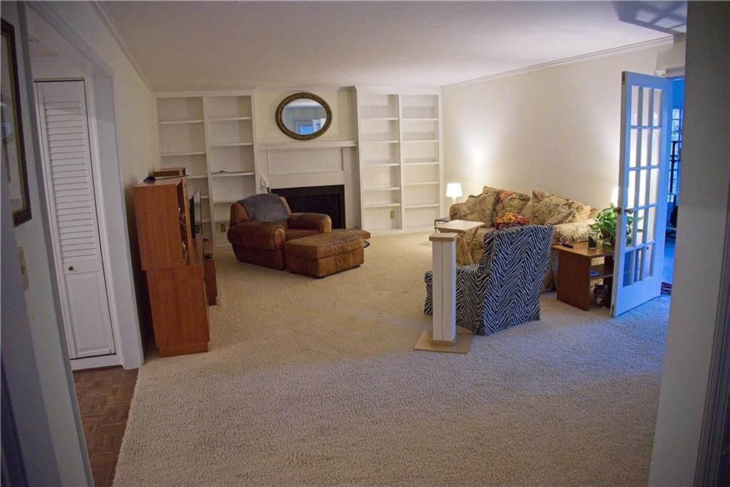 425 Hackberry Lane Roswell, GA 30076 - Photo 19 of 28 a living room with furniture a flat screen tv and a fireplace