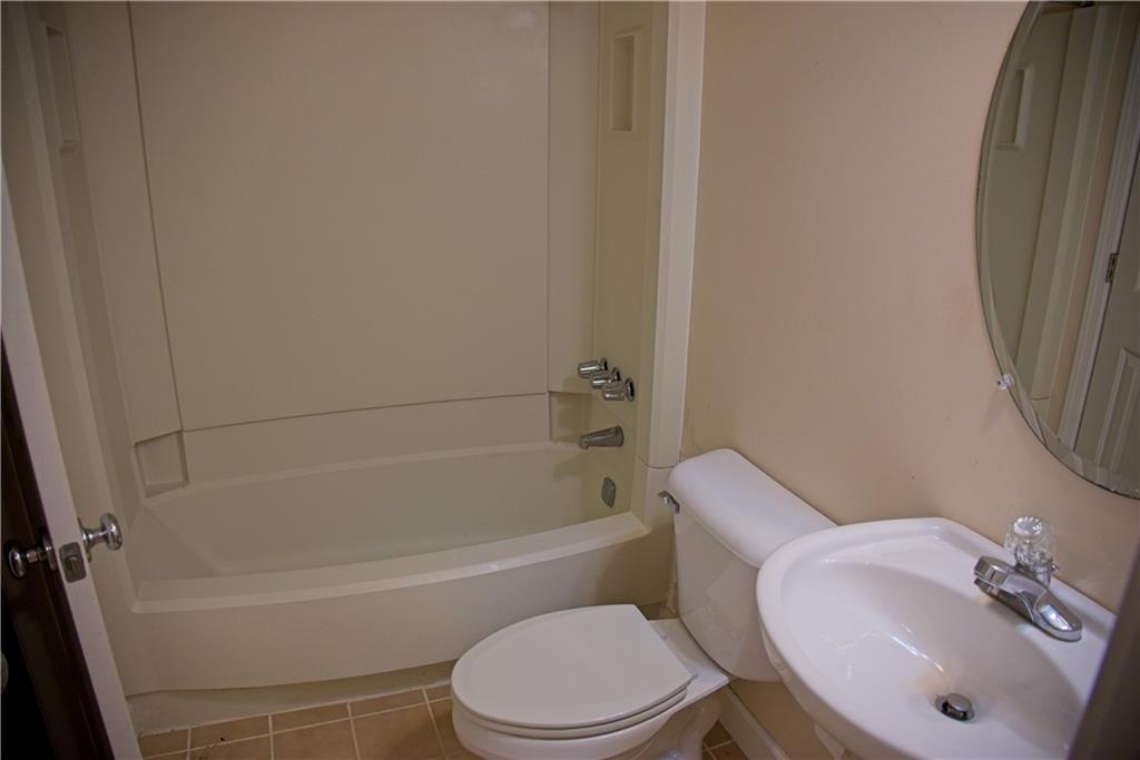 425 Hackberry Lane Roswell, GA 30076 - Photo 26 of 28 a white toilet sitting next to a bath tub