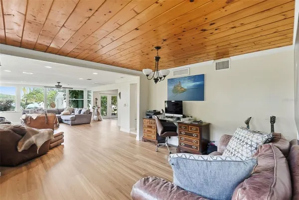 a bedroom with a large bed and a chandelier