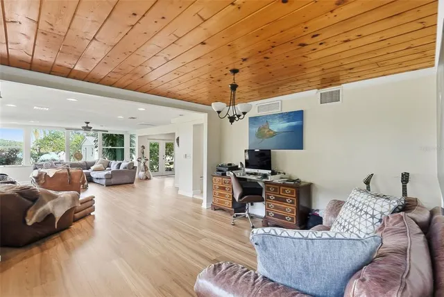 a bedroom with a large bed and a chandelier