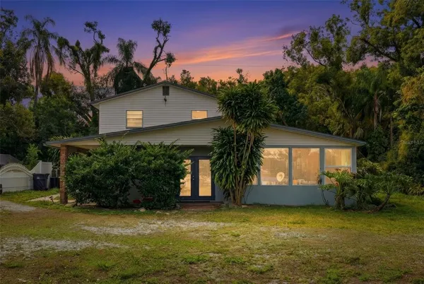 a view of a house with a yard and a garage