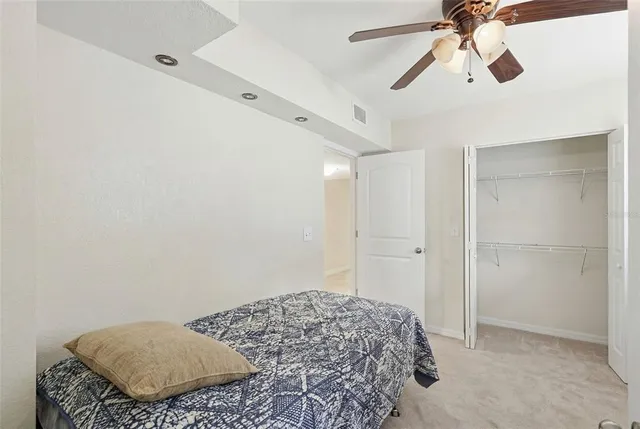a kitchen with granite countertop a refrigerator and cabinets