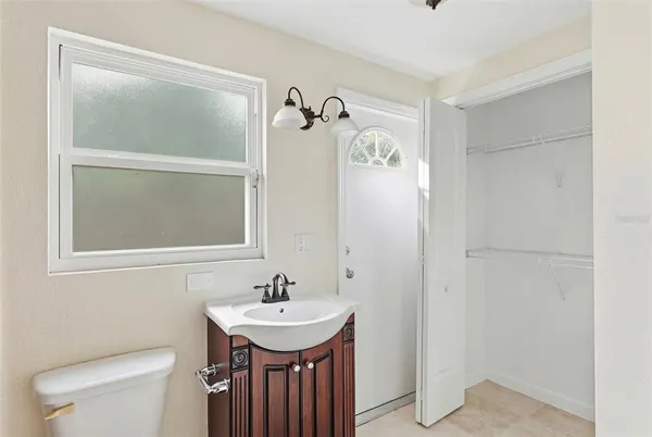 a kitchen with granite countertop a refrigerator and a sink