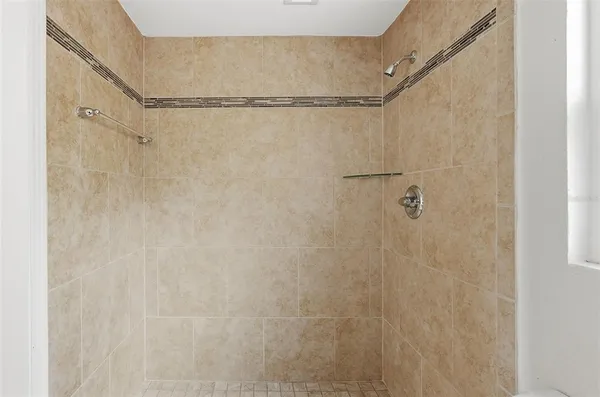 a bathroom with a granite countertop sink a toilet and mirror
