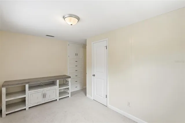 a house view with swimming pool and trees in the background