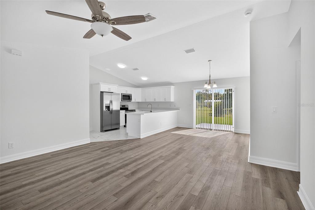 11145 2nd Avenue Punta Gorda, FL 33955 - Photo 3 of 9 a view of a kitchen with wooden floor a sink and a window