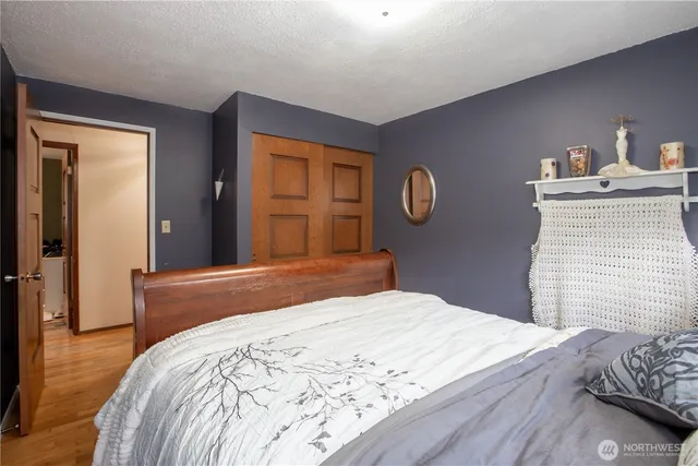 a bedroom with a bed and a dresser