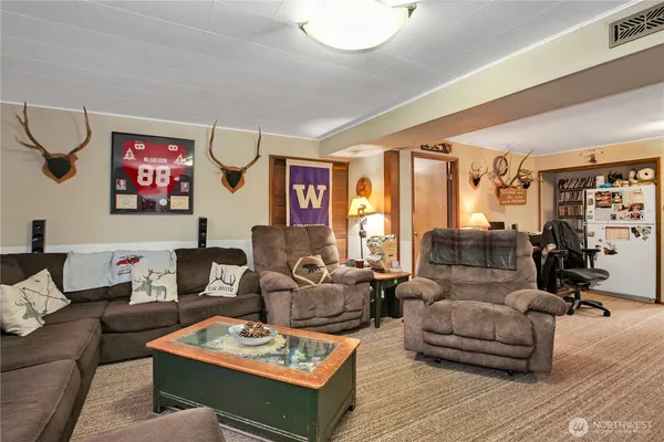 a living room with furniture a rug and a table