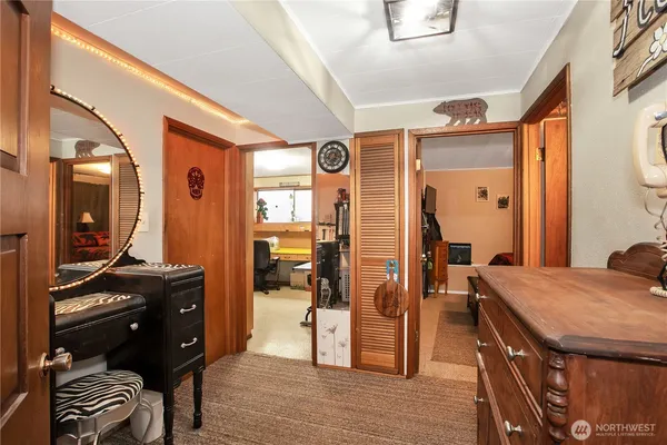a view of a hallway that has a bed and furniture