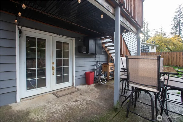 a view of a chairs and table in the back yard of the house