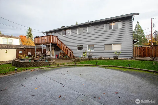 a front view of house with deck and outdoor seating