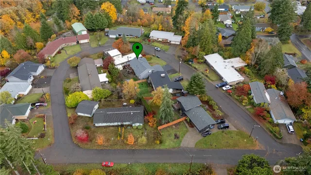 an aerial view of a house with a yard and lake view