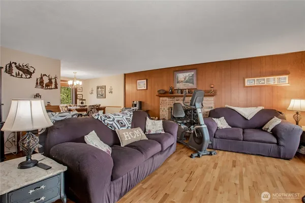 a living room with furniture a lamp and a flat screen tv