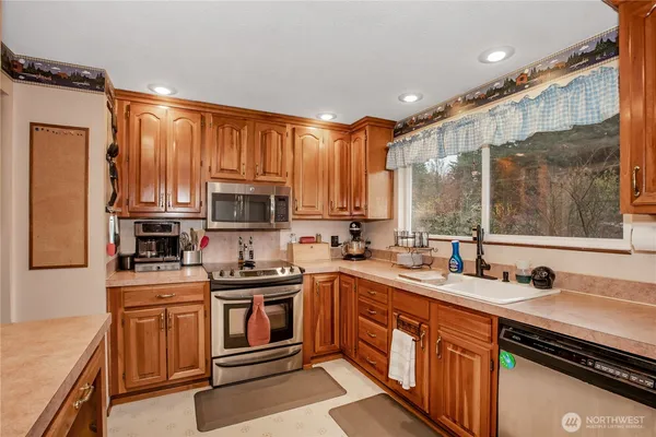 a kitchen with stainless steel appliances a sink stove and refrigerator