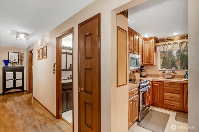 a view of a kitchen with stainless steel appliances granite countertop a refrigerator and a sink