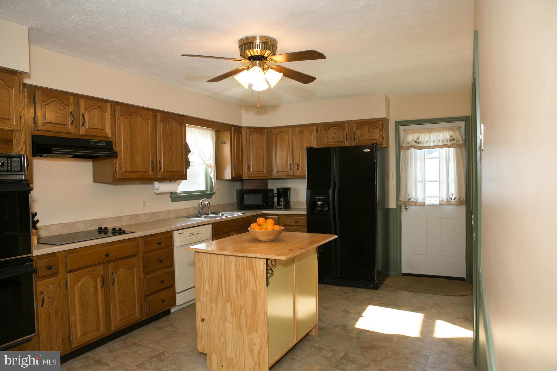 17609 Troyer Road White Hall, MD 21161 - Photo 3 of 30 a kitchen with a refrigerator a sink and dishwasher