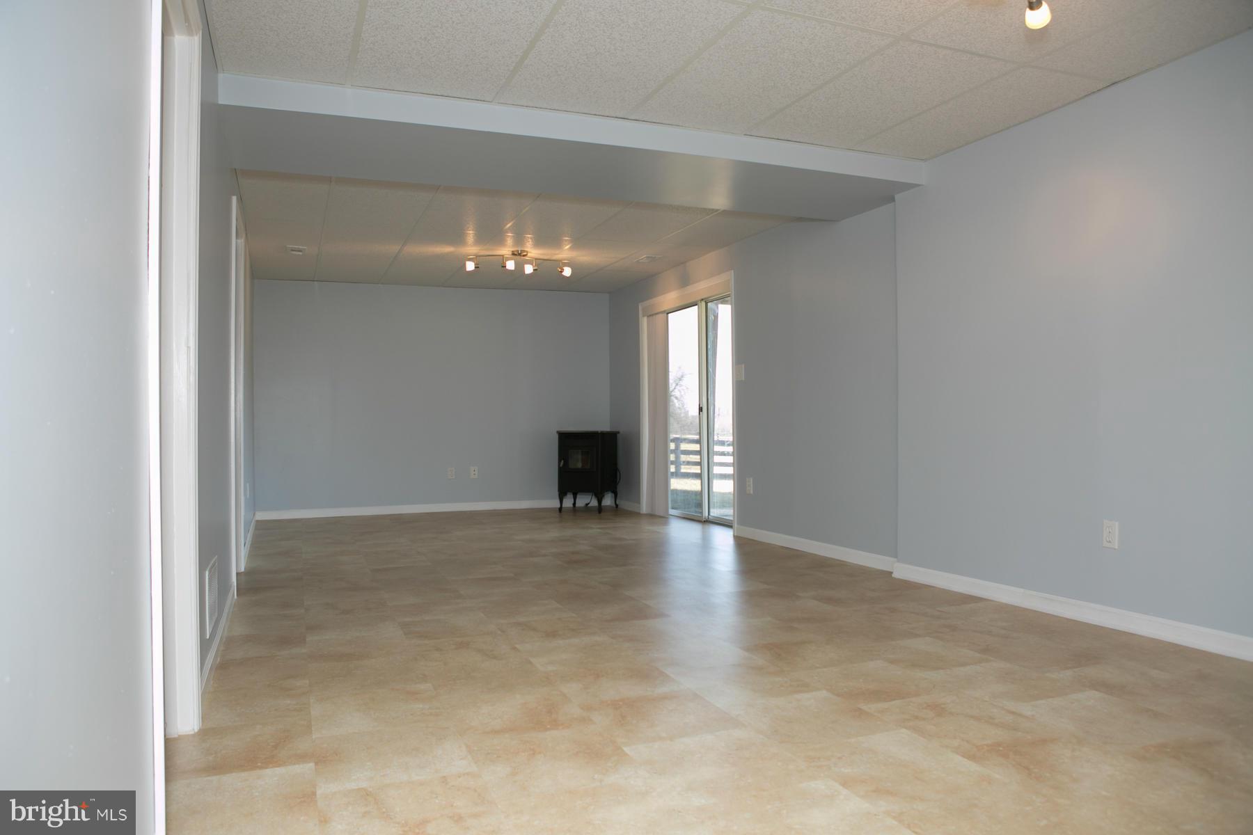 17609 Troyer Road White Hall, MD 21161 - Photo 22 of 30 a view of an empty room with a chandelier fan and fire place