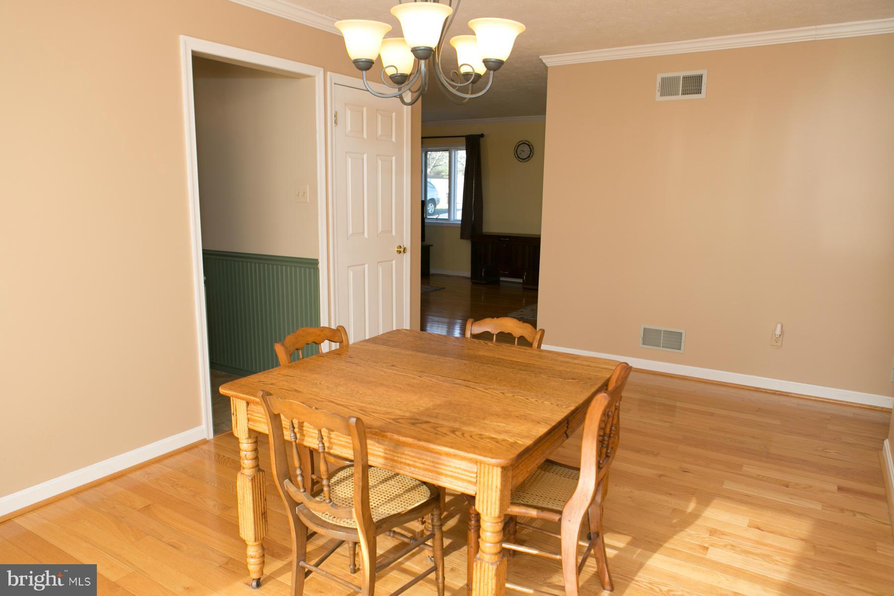 17609 Troyer Road White Hall, MD 21161 - Photo 4 of 30 a view of a dining room with furniture and a chandelier