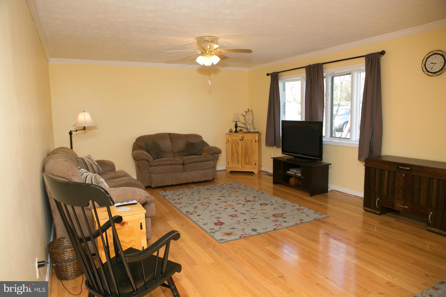 17609 Troyer Road White Hall, MD 21161 - Photo 6 of 30 a living room with furniture and a flat screen tv