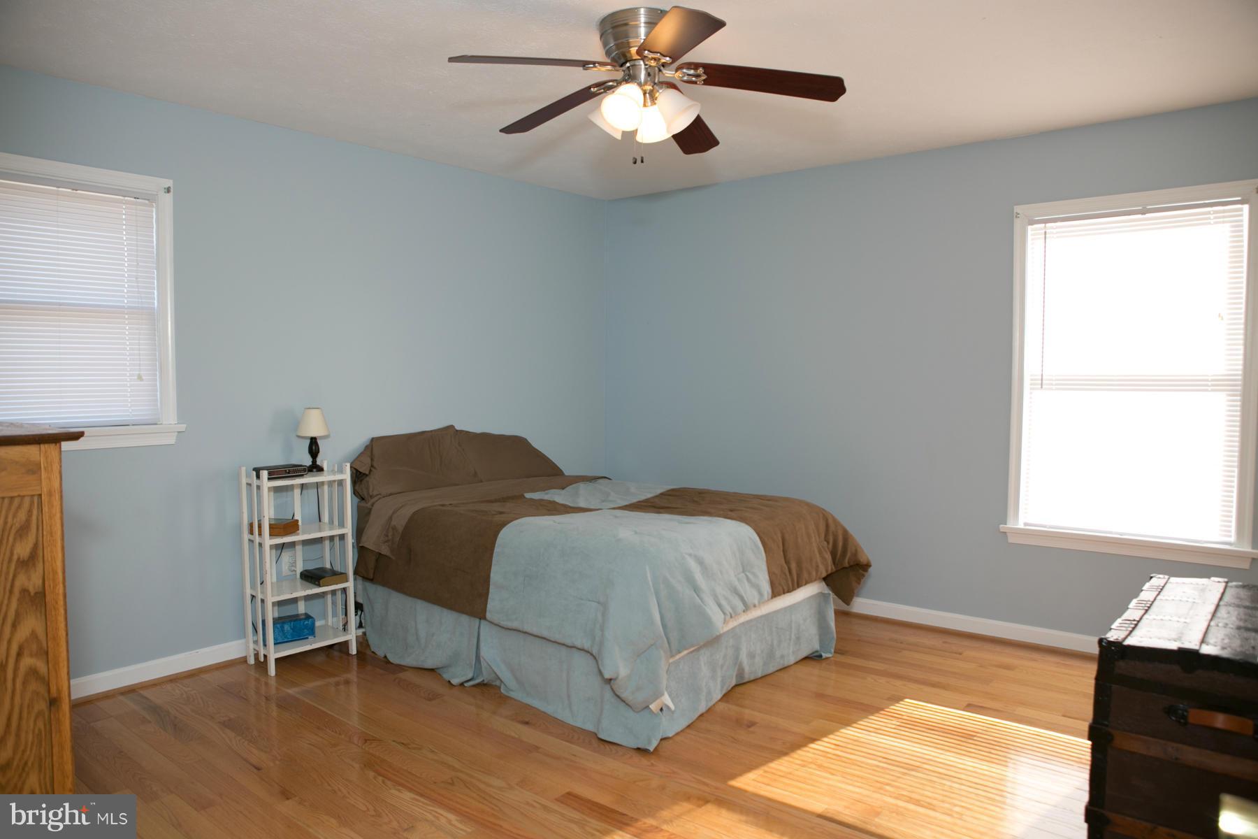 17609 Troyer Road White Hall, MD 21161 - Photo 9 of 30 a bedroom with a bed and a chandelier