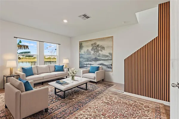 a living room with furniture and a large window