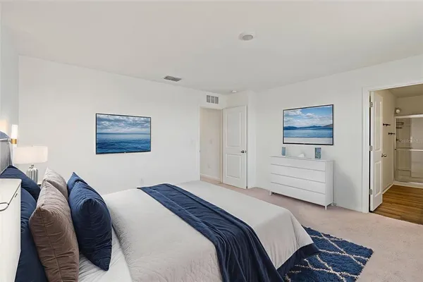 a bedroom with a bed and a couch