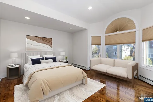 a bed room with a bed and a large window