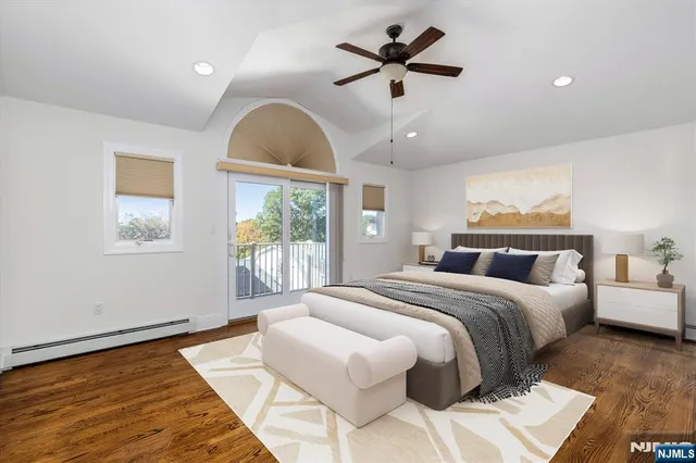 a spacious bedroom with a large bed and a chandelier