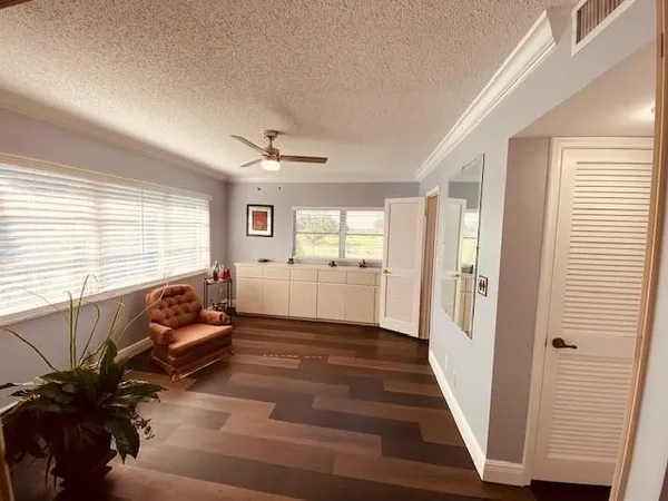 a balcony with wooden floor in front of a window