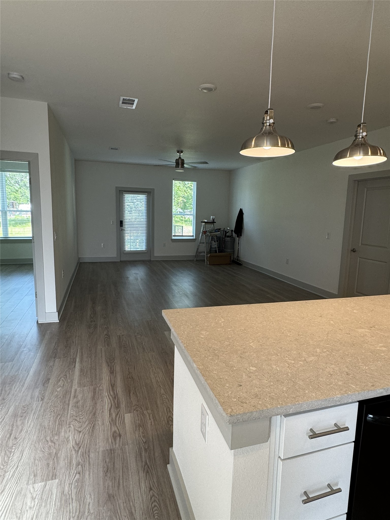26244 Twin Oaks Road Splendora, TX 77372 - Photo 2 of 10 a kitchen with kitchen island stainless steel appliances a dining table wooden floor and cabinets
