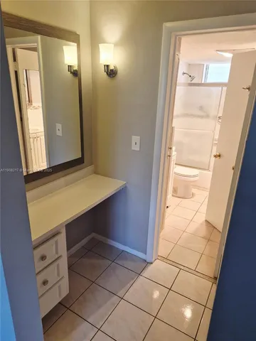 a bathroom with a sink mirror vanity and toilet