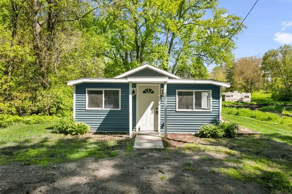 a front view of a house with a yard