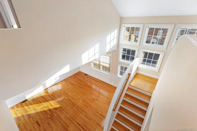 a view of hallway with furniture and wooden floor