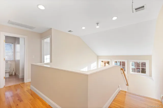 a view of room with window and wooden floor