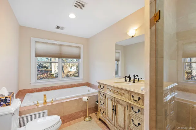 a bathroom with a granite countertop sink a mirror and a shower