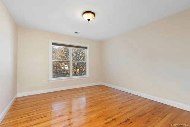 a bathroom with a granite countertop toilet and a sink