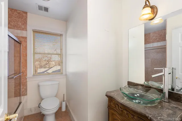 a bathroom with a sink toilet and shower