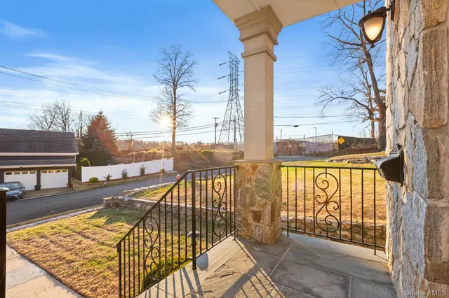 a view of a balcony with wooden floor and fence