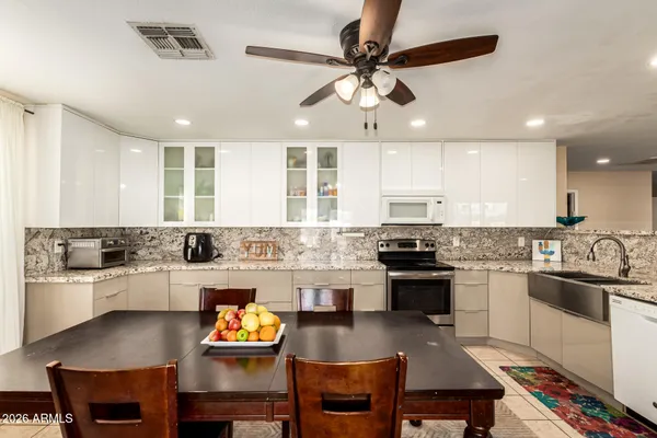 a kitchen with a stove cabinets a sink and a stove