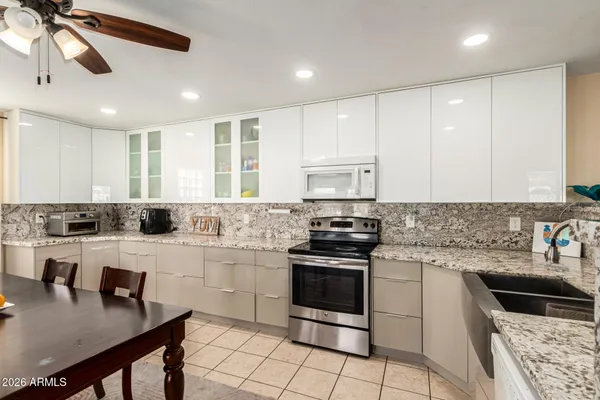 a kitchen with stainless steel appliances a stove sink microwave and cabinets